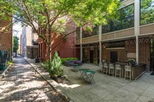 a patio with tables and chairs in front of a building at The Heart of OTR - Central studio apartment in Cincinnati