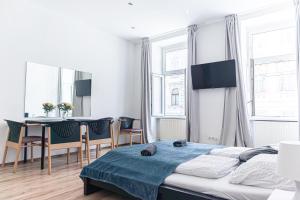 a bedroom with a bed and a table and chairs at Budget Apartments Well connected to the Whole City in Vienna