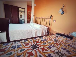 a bedroom with a bed with a pattern on it at Villa Hirschen in Zafferana Etnea