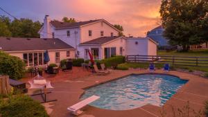 a backyard with a swimming pool and a house at Historic Farmhouse with Pool - Sleeps 10 in Union