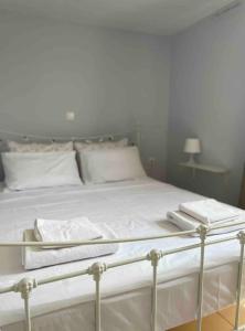 a bed with white sheets and towels on it at Summer Sea Home in Nerántza