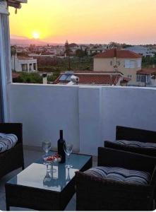 a table with wine glasses and a view of a sunset at Summer Sea Home in Nerántza +4 photos