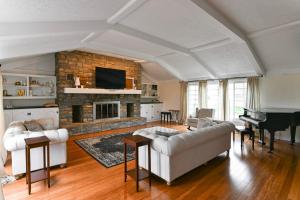 a living room with a couch and a piano at Historic Farmhouse with Pool - Sleeps 10 in Union