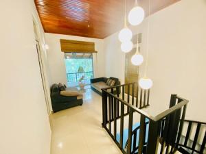 a living room with a staircase and a couch at The Shade Brothers in Katunayake