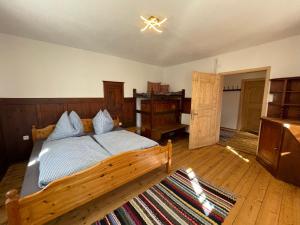 a bedroom with a wooden bed with blue pillows at Egger's Sonnenhof Thurn in Thurn