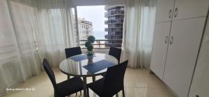 a dining room with a table and chairs and a window at PISO CALPE - 2º LINEA in Calpe