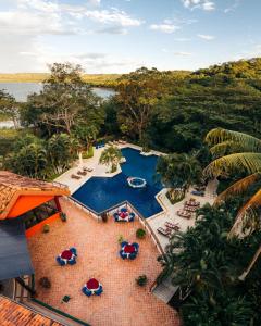 an overhead view of a swimming pool with chairs and umbrellas at Papagayo Golden Palms Beachfront Hotel in Papagayo, Guanacaste