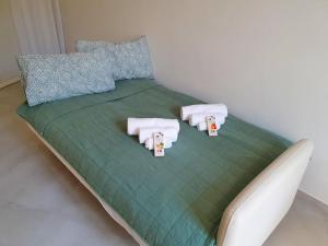 a bed with towels and pillows on top of it at Casa Svea in Avola