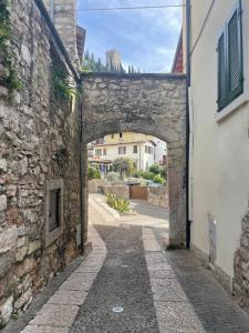 an archway in an alley between two buildings at ON the RAIL by Arcotrilogy-Homes in Arco