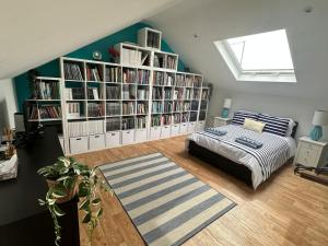 a bedroom with a bed and a book shelf with books at Tankerton Beach Daze in Kent