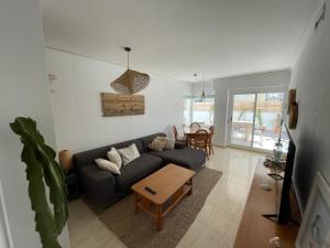 a living room with a couch and a table at Casa cactus Piles Playa in Piles