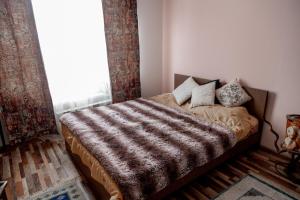 En eller flere senge i et værelse på Тепло и Уют