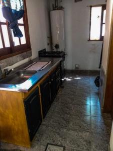 a kitchen with a sink and a counter top at LA TRANQUERA DPTOs in Río Cuarto