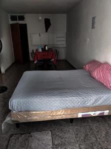 a large bed in a room with a table at LA TRANQUERA DPTOs in Río Cuarto