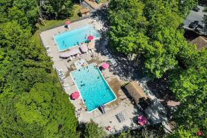 an overhead view of a swimming pool and trees at Whispering Woods in East Stroudsburg