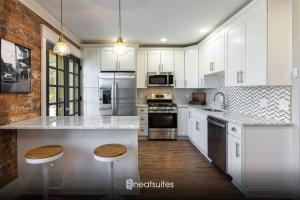 a kitchen with white cabinets and white counter tops at 2BR Townhome with Parking - Walk to Stadiums & Downtown in Covington