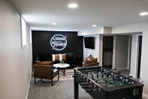a living room with a giant foosball table in the middle at The Gilded Cincy-View Condo in Covington