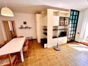 a living room with a table and a dining room at Frau, grazioso trilocale in centro a Numana con spazio esterno in Numana +15 photos