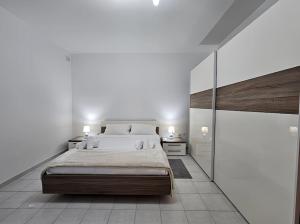 a bedroom with a large bed and a large mirror at Ruby Heaven Apartment in St Paul's Bay