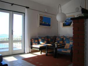 a living room with a couch and a table at Kornati Paradise Residence Slanica in Murter