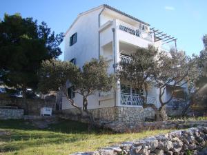 a white house with trees in front of it at Kornati Paradise Residence Slanica in Murter