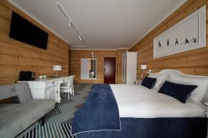 a bedroom with a large white bed and a desk at New Willa Jan in Zakopane