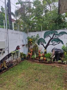 a wall with a mural of elephants and other animals at Perivale in Moratuwa