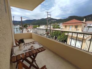 a balcony with a table and a view of a city at Απόλλων in Apóllona