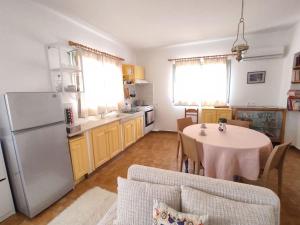 a kitchen with a table and a refrigerator at Απόλλων in Apóllona