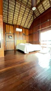 a large room with a bed in the middle of it at Pousada Amor Do Arpoador in Tutóia