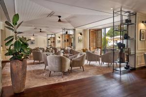 a waiting room with chairs and a table at The Cliff Bay - PortoBay in Funchal