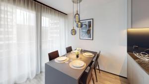 a dining room with a table and chairs and a window at block E, 13 Sonnentalstrasse in Zurich
