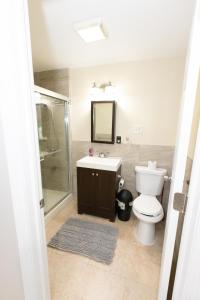 a bathroom with a toilet and a sink and a shower at Bright & Spacious 2-bed near NYC in Jersey City