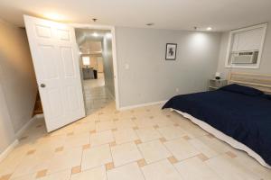 a bedroom with a bed and a wooden floor at Bright & Spacious 2-bed near NYC in Jersey City