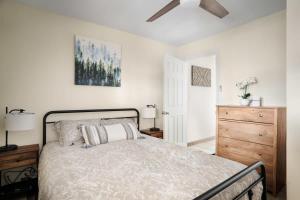 a bedroom with a bed and a ceiling fan at Modern Mountain Cottage w Hot Tub, Fire Pit, WiFi in Inwood
