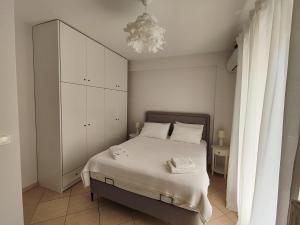 una camera con letto e armadietto bianco di Philoxenia Apartments a Plataria