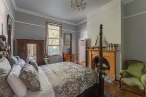 a bedroom with a bed and a fireplace at Derby Bank House- Heritage listed two bedroom old school B&B suite or a self contained cabin in Derby
