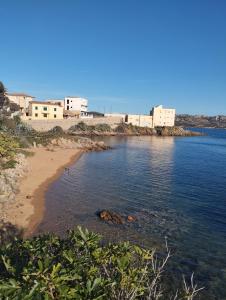 a view of a beach with buildings in the background at La Maddalena b&b da Marco in La Maddalena