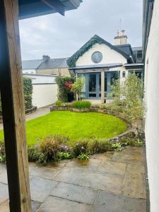 a house with a garden in front of it at Bushmills Townhouse in Bushmills