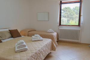 a hotel room with two beds and a window at Country Home in Crispiano