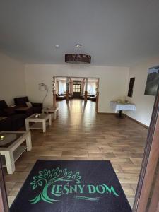 a living room with a couch and a rug on the floor at Leśny Dom in Barlinek