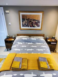a bedroom with a bed with yellow towels on it at Large light loft room - en suite in Brighton & Hove