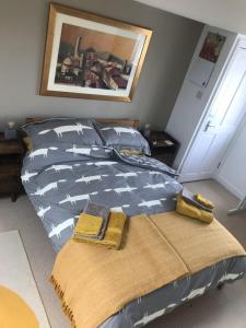 a bed with two towels on it in a bedroom at Large light loft room - en suite in Brighton & Hove