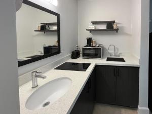 a bathroom with a sink and a mirror at Studio 6 Conroe, TX in Conroe +19 photos