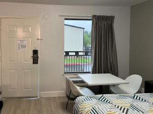 a room with a bed and a table and a window at Studio 6 Conroe, TX in Conroe