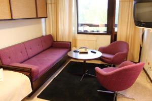 um quarto com um sofá e duas cadeiras e uma mesa em Ali baba's Amigo, vandrarhem long stay em Emmaboda