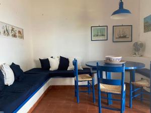 Habitación con cama, mesa y sillas. en Pantelleria, villetta sul mare, en Scauri