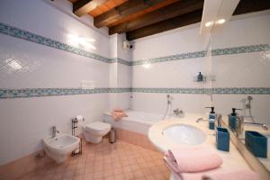 a bathroom with a sink and a toilet at Casa sul Porto in Desenzano del Garda