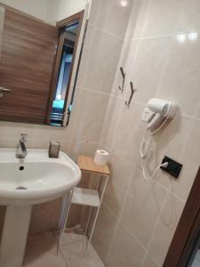 a bathroom with a white sink and a mirror at Calipso Bed&Breakfast in Catania +21 photos