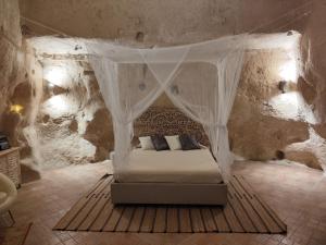 a bedroom with a bed in a stone room at Stone House in Matera